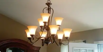 Classic ceiling chandelier installation with warm lighting in Minneapolis, MN