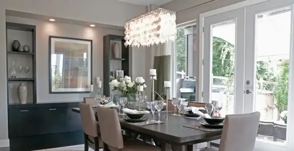Elegant dining room chandelier installation above table in Minneapolis, MN