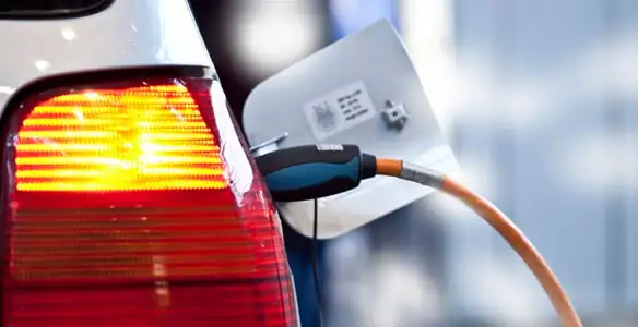 Electric car plugged into EV charger after professional installation in Minneapolis, MN
