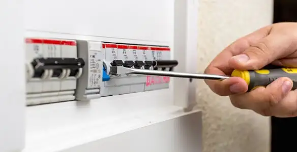 electrical panel upgrade service showing technician adjusting circuit breakers during system upgrade in Minneapolis, MN