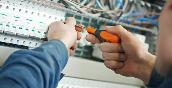 electrical service showing licensed electrician performing electrical panel maintenance and adjustments in Minneapolis, MN