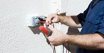 Electrician performing home electrical outlet and wiring inspection in Minneapolis, MN