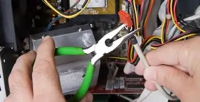 Licensed electrical contractor performing electrical repair with tools in South Saint Paul, MN