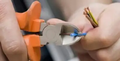 professional electrical services showing precise wire cutting by licensed electricians in Minneapolis, MN