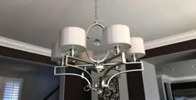 Modern chandelier installation with multiple light fixtures in Minneapolis, MN