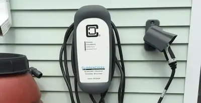 Outdoor electric vehicle charger installation on residential wall in Minneapolis, MN