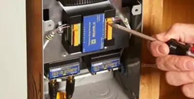 Whole home surge protection device being installed by a licensed electrician to protect electrical systems in Minneapolis, MN